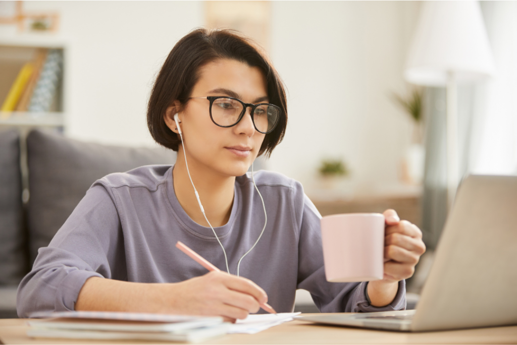 women drinking coffee while writting