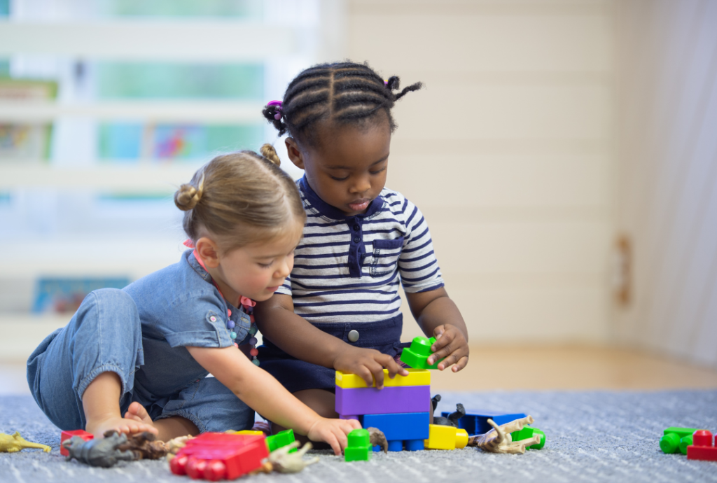 two toddlers playing with toys together